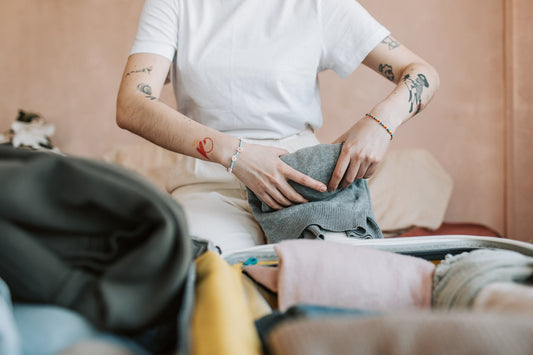 woman rolling clothes for packing