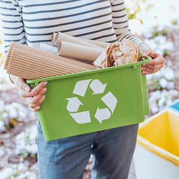 Activist taking care of environment, sorting paper waste to proper recycling bin on terrace