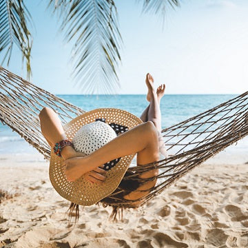 traveler asian woman with white bikini relax in hammock on beach