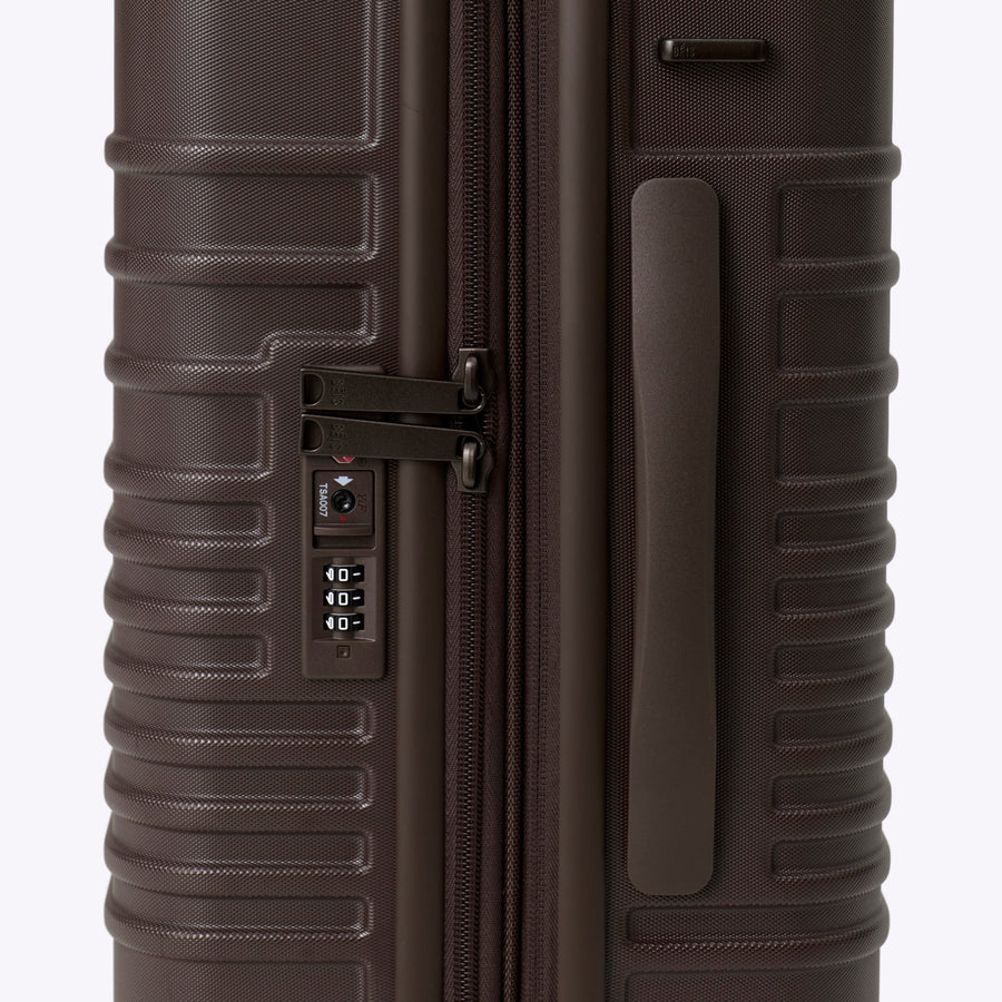 Brown suitcase with a zipper on a white background