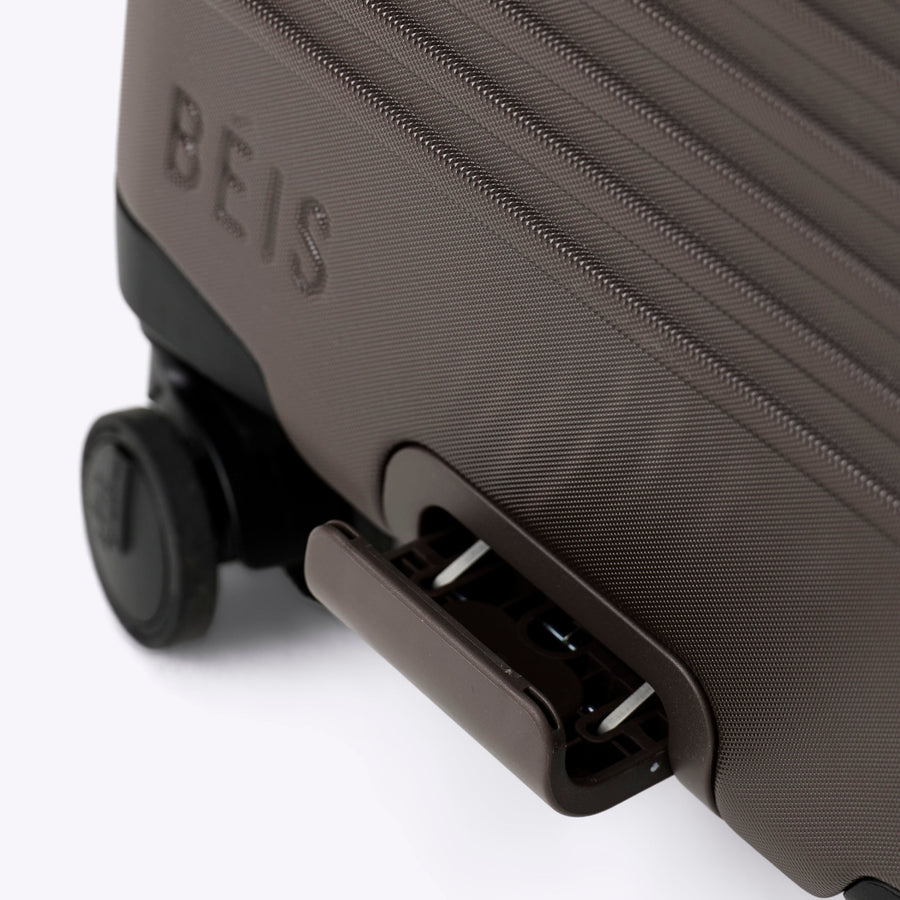 Dark gray suitcase with 'BEIS' branding on a white background