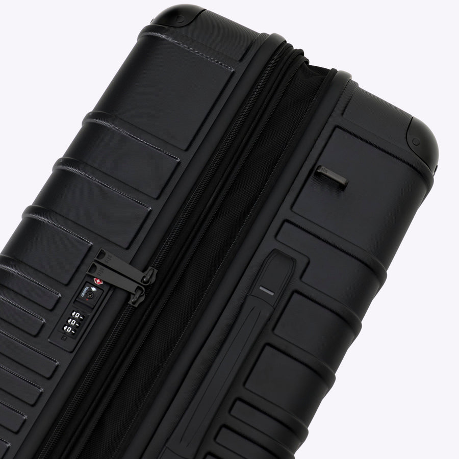 Black suitcase with textured surface on a white background
