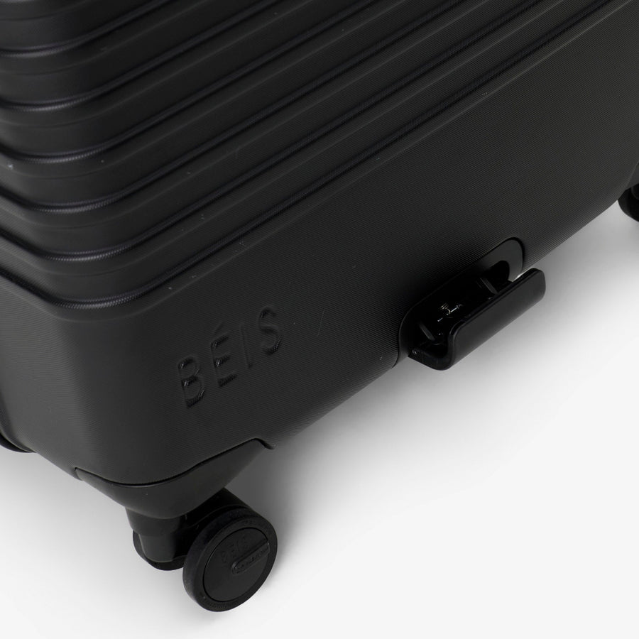 Black suitcase with 'Bee' branding on a white background