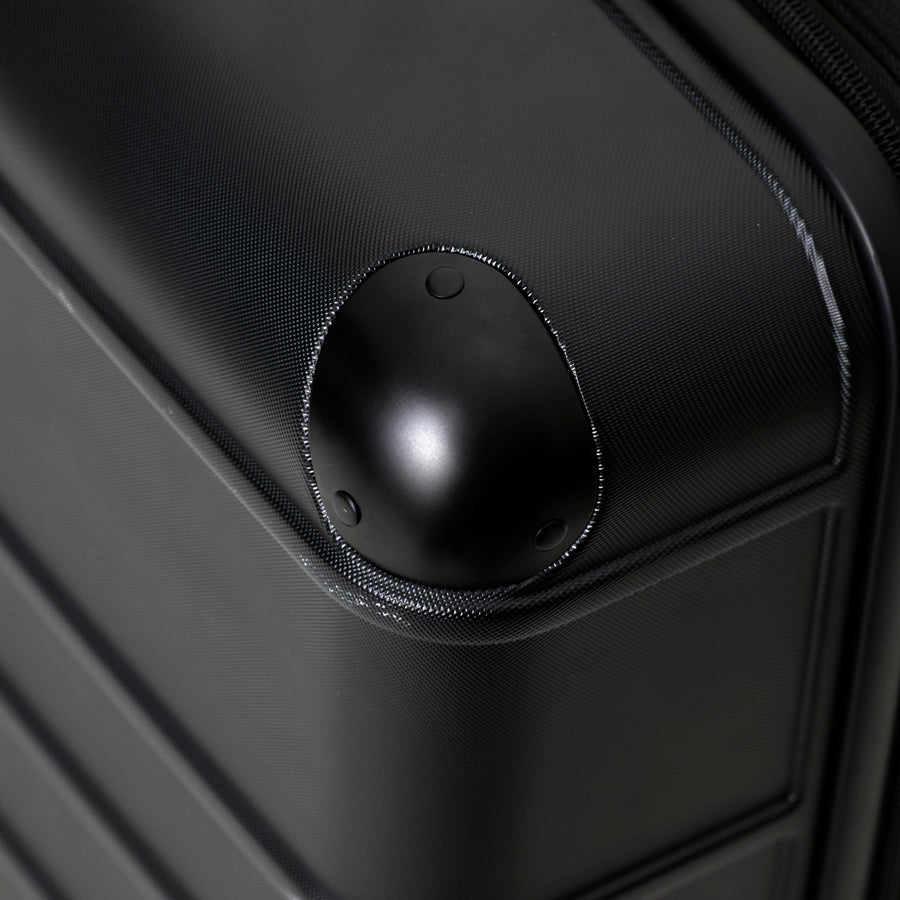 Close-up of a black suitcase handle