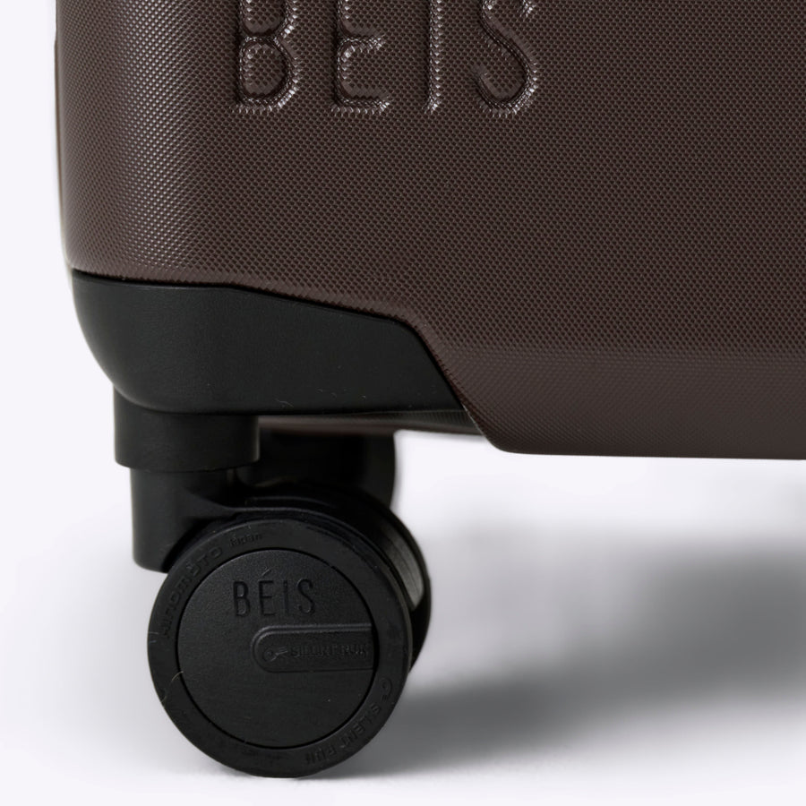 Brown suitcase with 'BEIS' branding on a white background