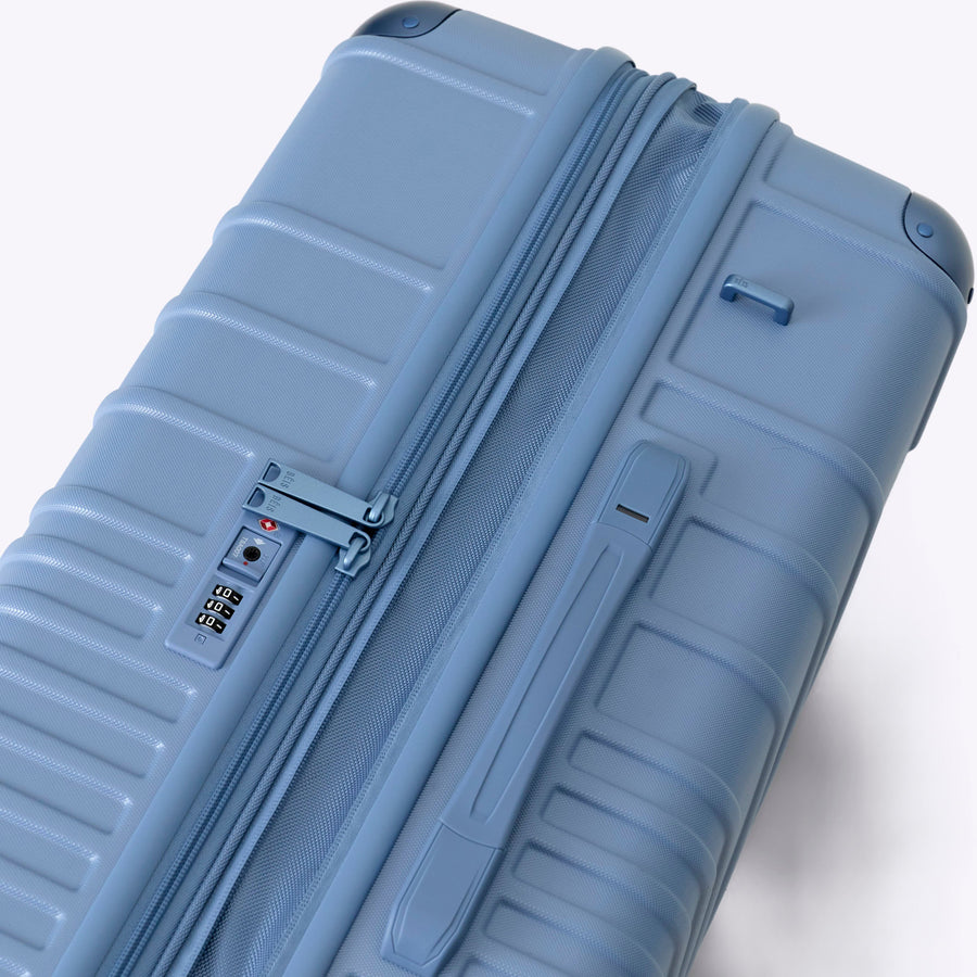 Blue suitcase on a white background