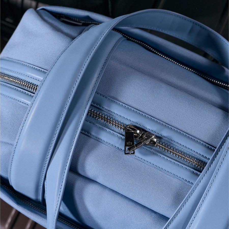 Blue backpack with zippers on a suitcase