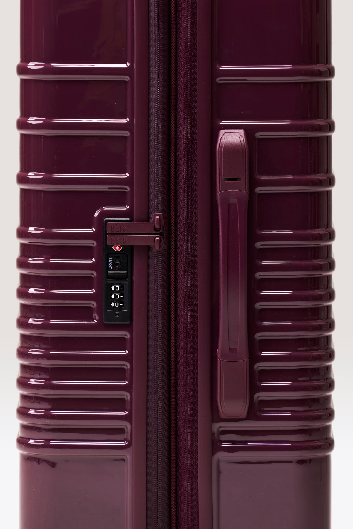 The Medium Check-In Roller in Glossy Plum