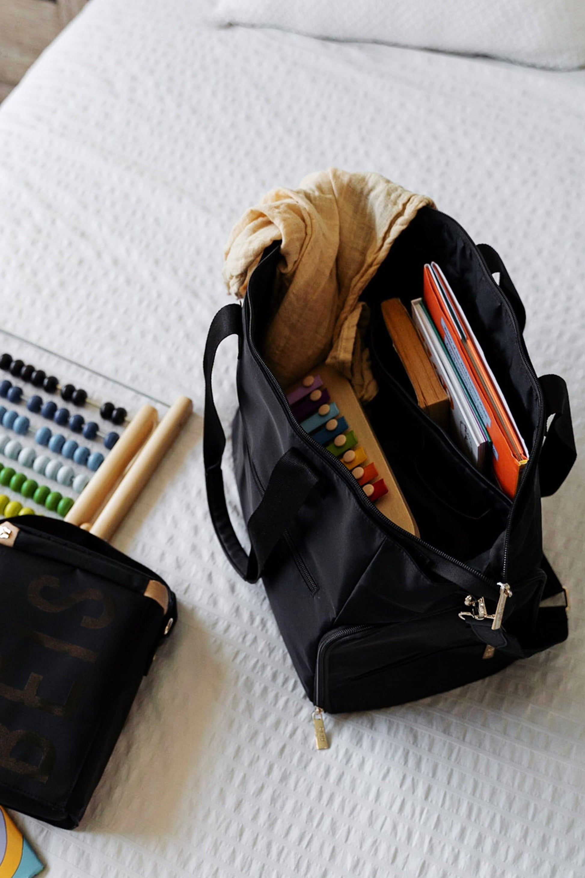 Pumping Bag Black Filled with Children's Toys on Bed