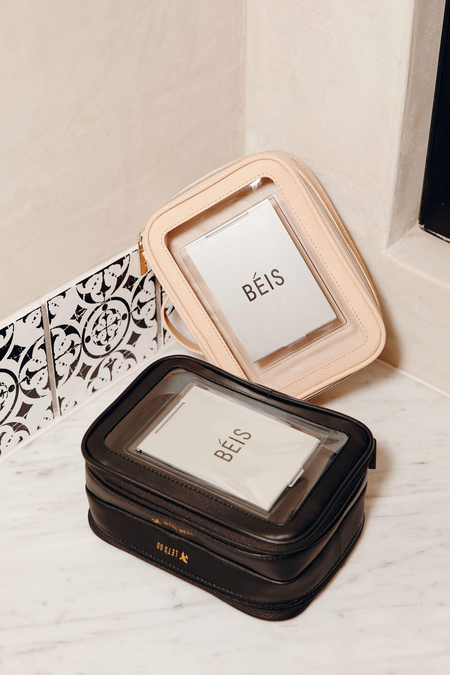 BEIS by Shay Mitchell | The On-The-Go Essential case in Black on marble countertop next to beige cosmetic case
