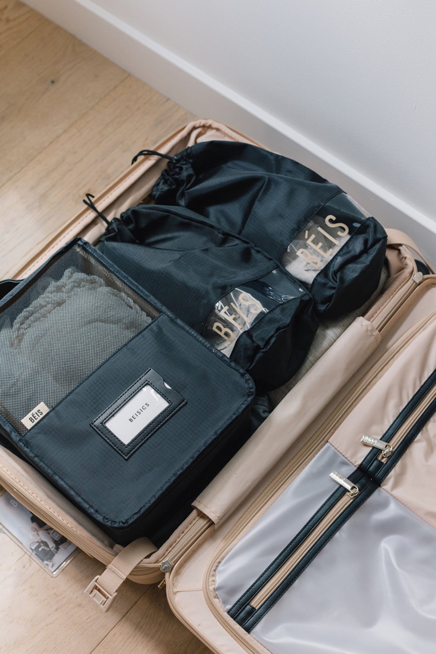 Packing Cubes Black Packed into Beige Suitcase